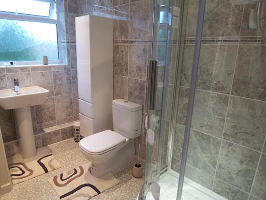 marble tiled shower room