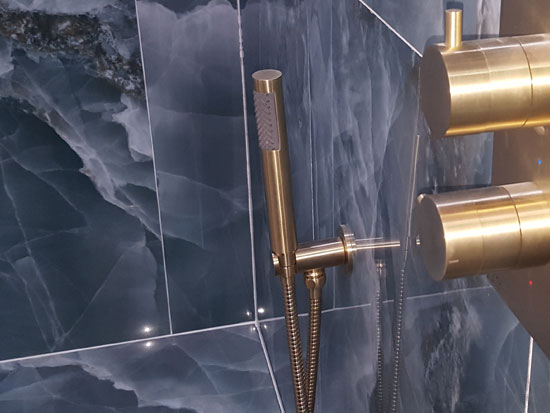 Shower enclosure with gold fittings